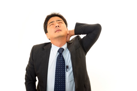 寝違えをして首が痛いサラリーマンの写真